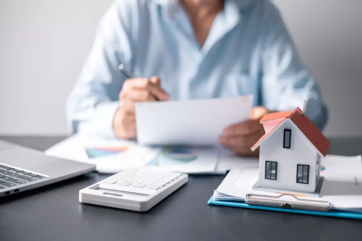 man doing calculations for mortgage