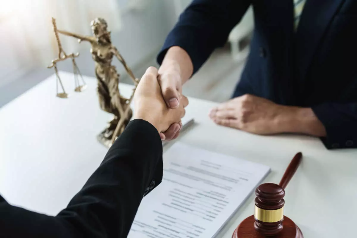 Individual shaking hands with attorney 