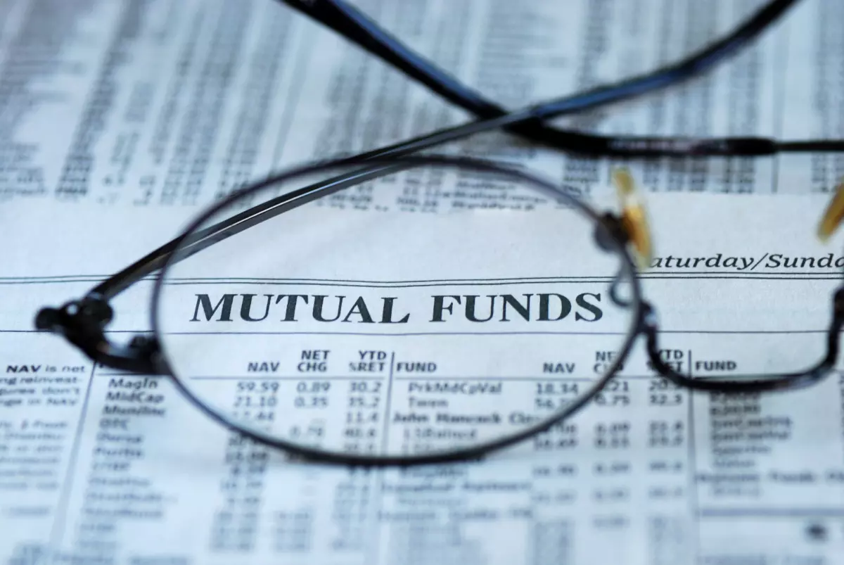 Glasses on top of newspaper with mutual funds information