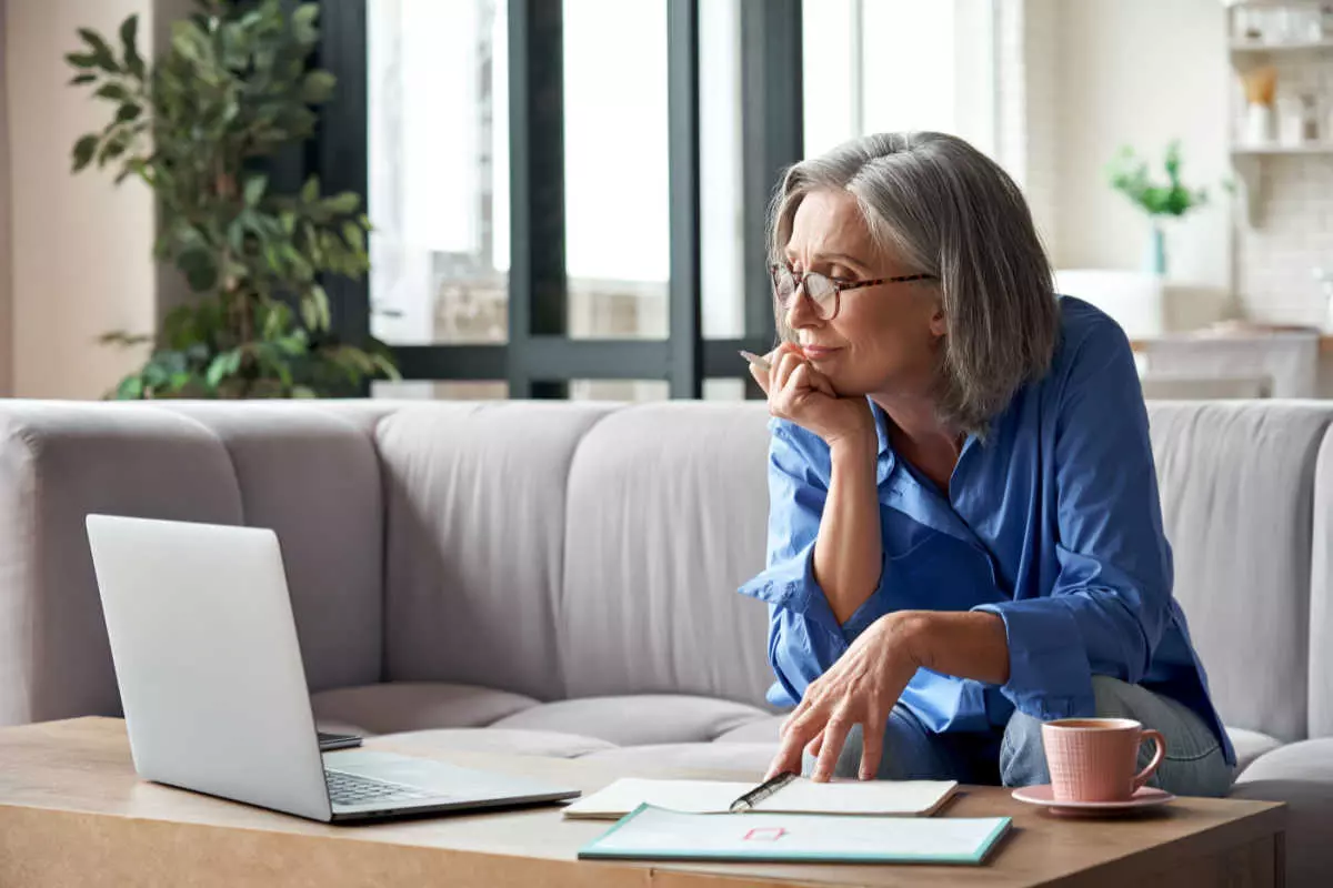 Retiree researching pension plan on laptop